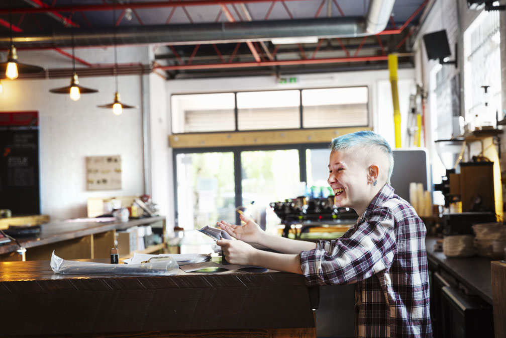 Woman laughing in a coffee shiop